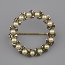 Stříbrná brož ve tvaru věnce osázená perličkami